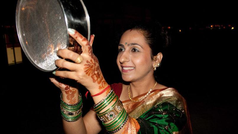 "Karva Chauth" - Fasting women looking at the moon through a sieve