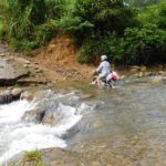 Moped crossing a river