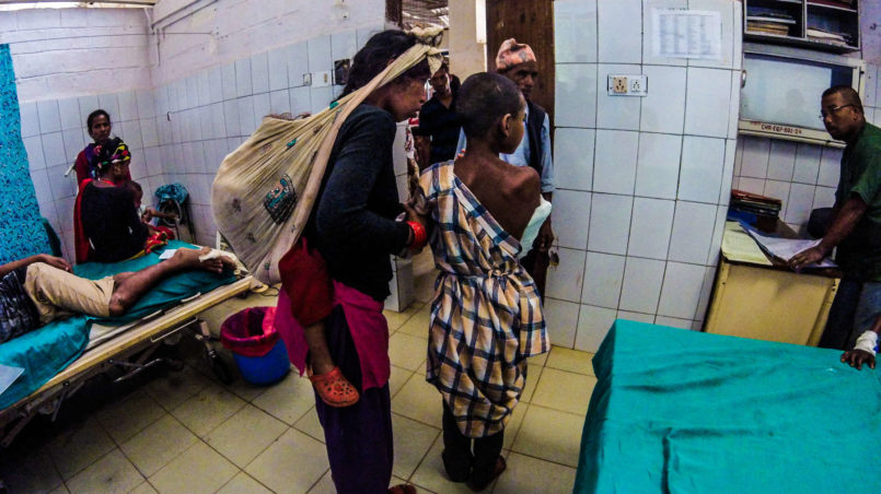 Young boy and his family in the emergency room. Mothers carry their children on the back because it is easier due to the long walking distance they have to cover.