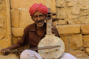 Musician playing the Kamaicha, a traditional string based instrument from Rajasthan-